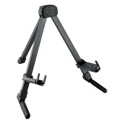 17550 Memphis Travel folding guitar stand front three-quarter view, black anodized legs with K&M logo on the rubber top cradle and adjustable body supports, K&M
