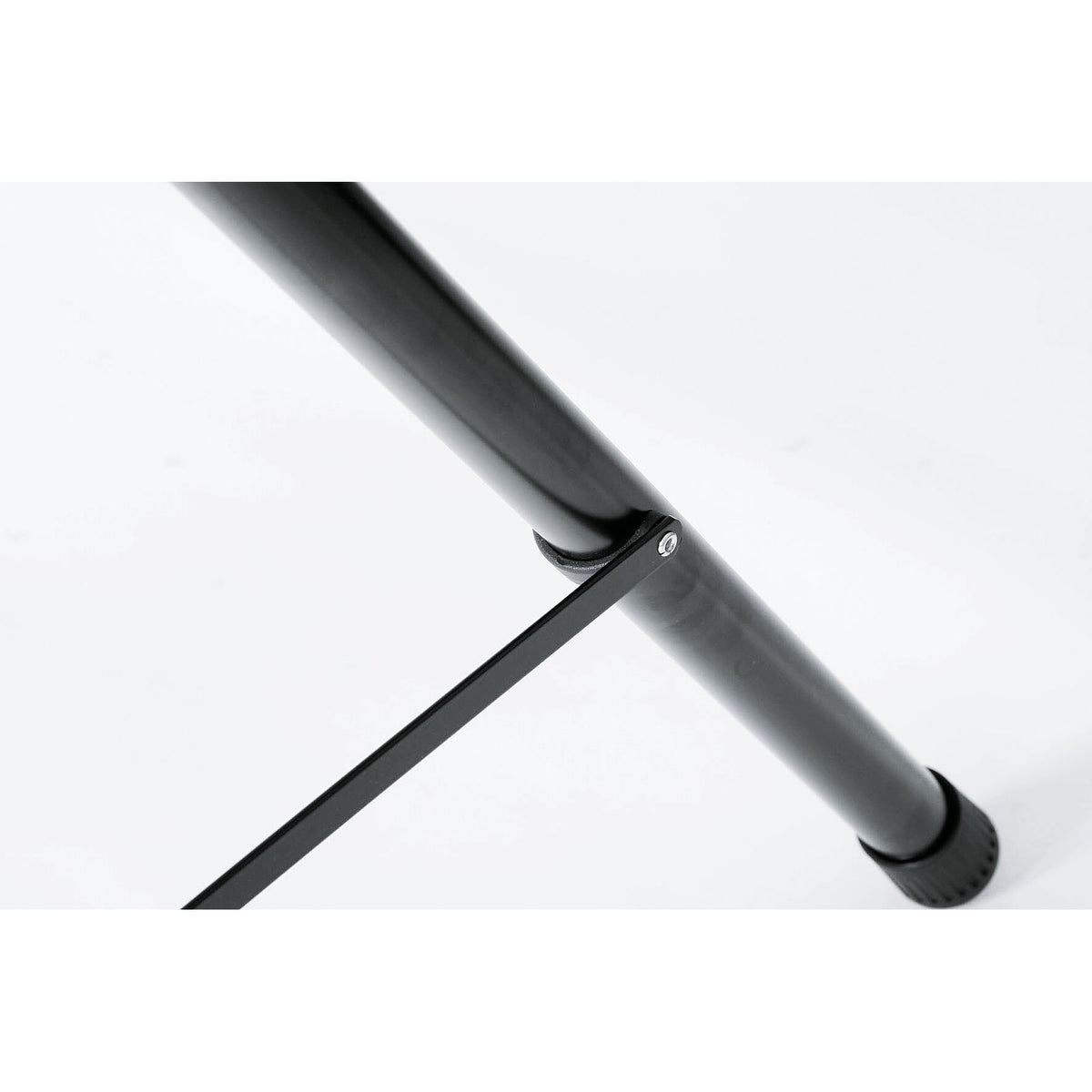 21436 speaker stand leg detail showing the flat brace strut riveted to the black aluminum leg tube above the rubber foot, K&M