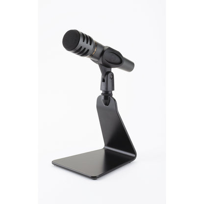 23250 flat base table microphone stand in use holding a black dynamic microphone in a clip, K&M