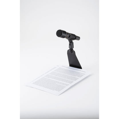 23250 flat base table microphone stand with microphone, base slid under a printed sheet of paper for reading at a desk, K&M