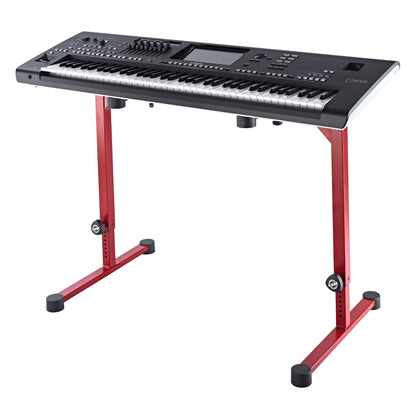 18810 Omega keyboard stand in ruby red holding a Yamaha Genos workstation keyboard on its rubber support pads, K&M