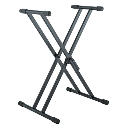 18990 double-braced X-style keyboard stand front three-quarter view in black with padded support tubes and rubber foot caps, K&M
