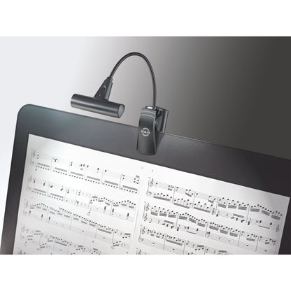 12247 LED FlexLight T-Model in use clipped to a music stand desk, gooseneck holding the light bar over sheet music, K&M