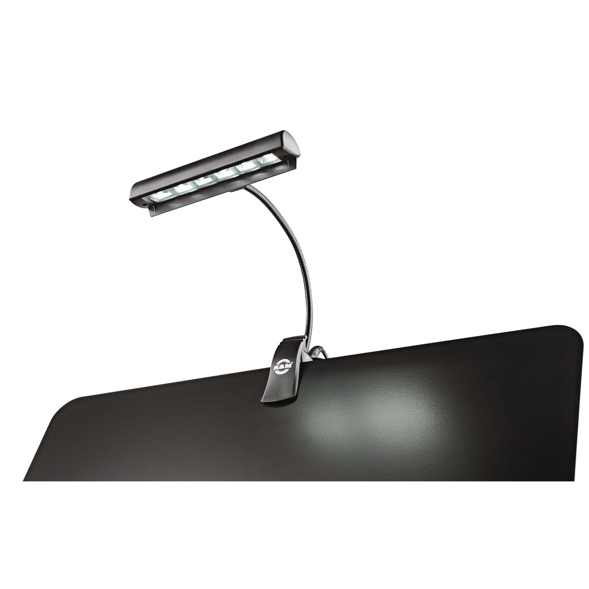 12248 Concert Orchestra music stand light mounted on a black stand desk with LEDs casting a pool of light on the surface, K&M