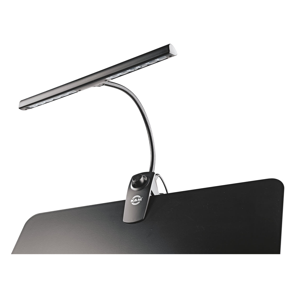 12295 music stand light clipped to the edge of a black music desk, unlit LED bar on gooseneck with dimmer knob on clip, K&M