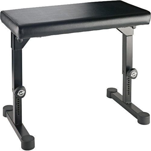 KM 14087.000.55 piano bench angled view showing padded black leatherette seat and height-adjustable black steel legs, K&M