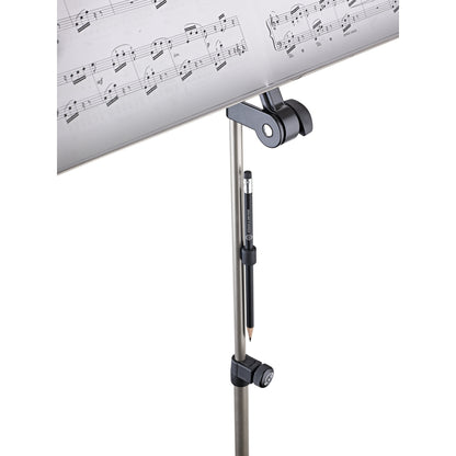 16099 magnetic pencil holder in use, clinging to the tube of a music stand below the sheet music desk with pencil held vertically, K&M