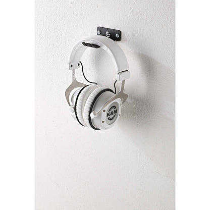 KM 16311.000.55 wall bracket mounted with two screws supporting white studio headphones by the headband, K&M