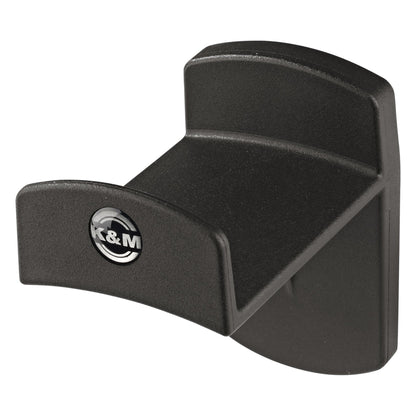 16312 headphone wall holder front three-quarter view showing curved black headband rest and K&M logo badge, K&M