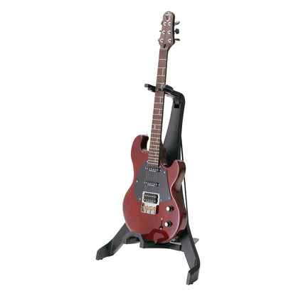 17650 Carlos folding guitar stand in use holding a red solid-body electric guitar upright by the neck, K&M