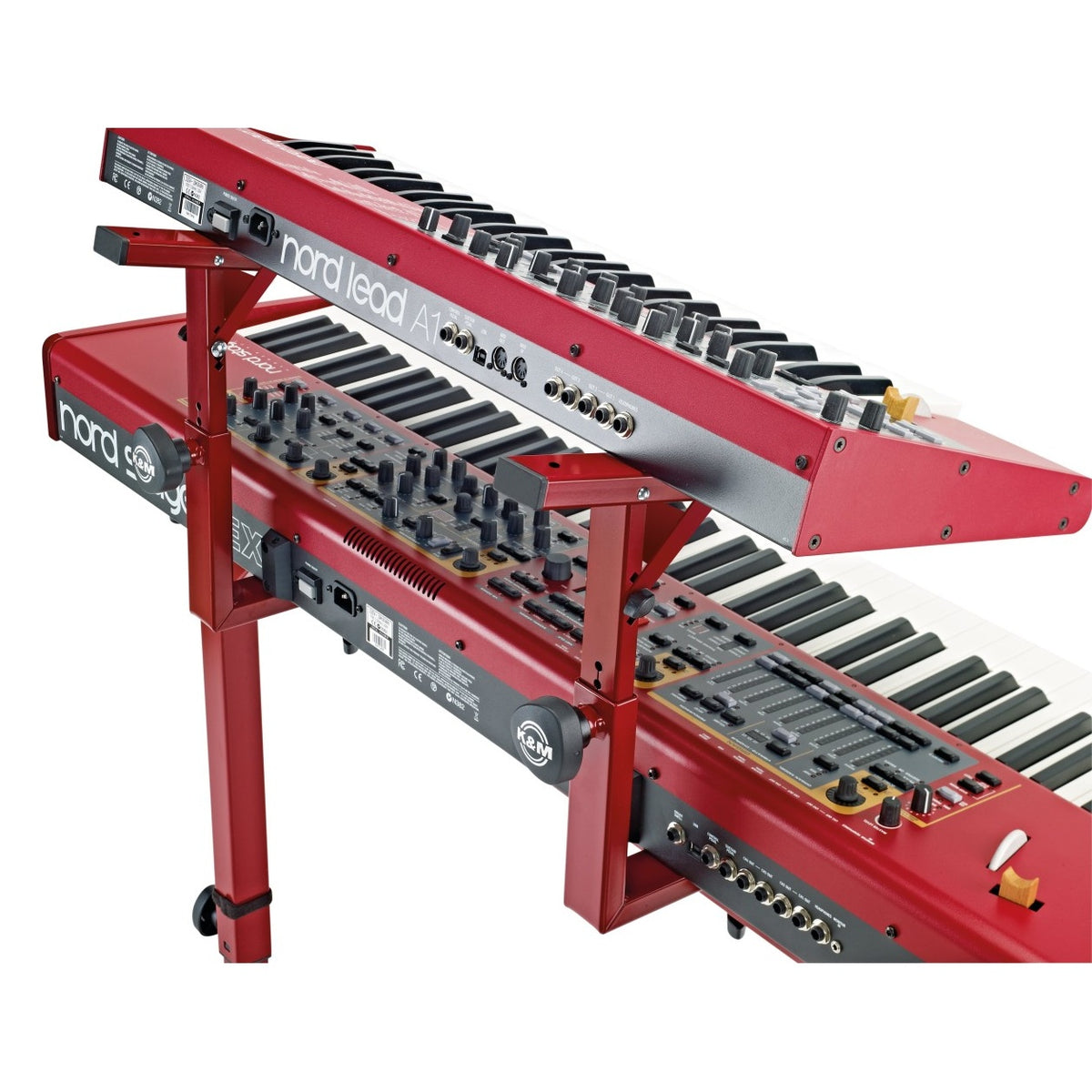 18811 Stacker second tier add-on in use, ruby red arms holding a Nord Lead A1 above a Nord Stage keyboard with K&M clamp knobs visible, K&M