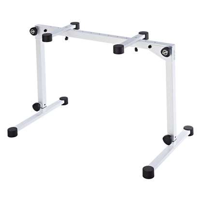 18820 Omega Pro keyboard stand in pure white, three-quarter view at lowest height setting with legs collapsed to the bottom of the telescoping columns, K&M