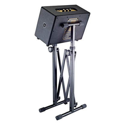 18826 equipment stand side view holding a guitar amplifier at an angle on the padded support arms, K&M