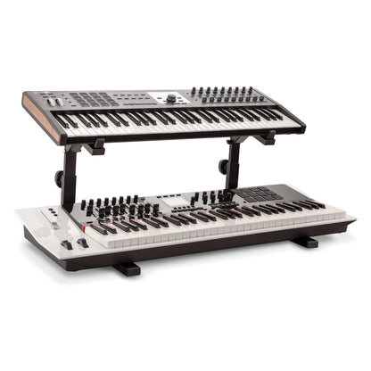 18828 Omega table stand basic support with 18811 stacker holding a keyboard above a second white keyboard on the floor-level base, K&M