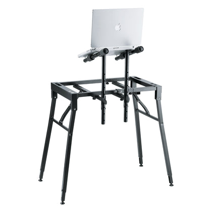 18950 table-style keyboard stand rear view with laptop resting on two padded tier arms and perforated height-adjustable posts, K&M