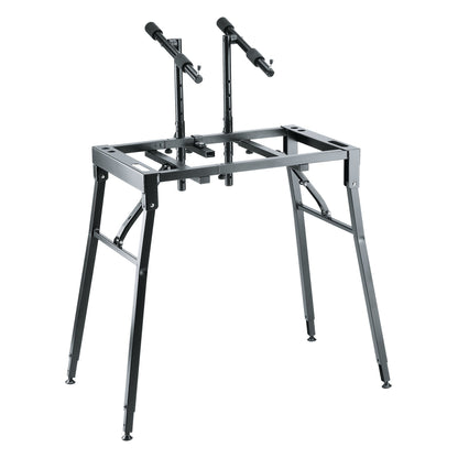 18950 table-style keyboard stand fitted with two perforated upright posts and padded T-arms for a second tier, K&M