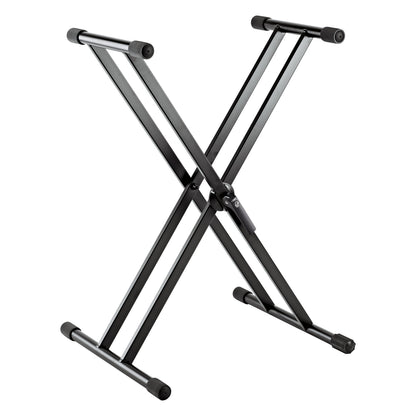 18997 double-braced X keyboard stand, three-quarter front view with crossed black aluminum legs and rubber-capped support arms, K&M