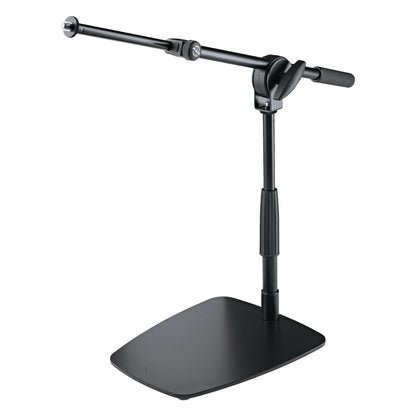 25993 low-profile mic stand front three-quarter view with telescopic boom extended left and flat black base, K&M