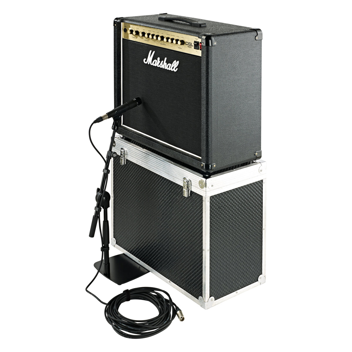 25993 low-profile mic stand in use positioning a microphone at a Marshall guitar combo amp stacked on a flight case, with XLR cable coiled on the floor, K&M