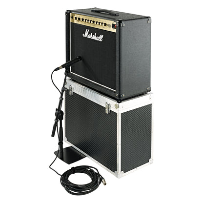 25993 low-profile mic stand in use positioning a microphone at a Marshall guitar combo amp stacked on a flight case, with XLR cable coiled on the floor, K&M