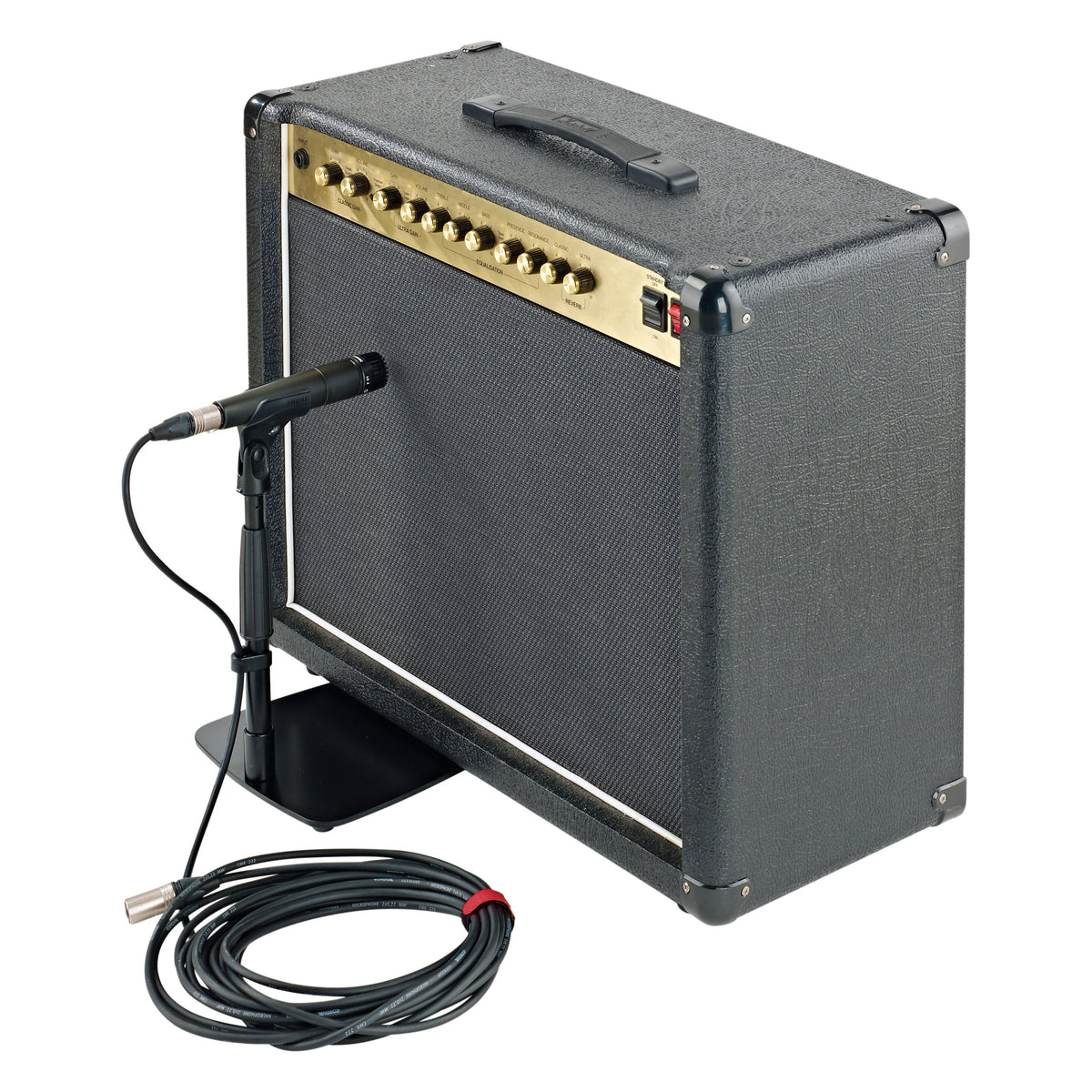 25993 low-profile mic stand in use holding a microphone at the grille of a guitar combo amp, with coiled XLR cable, K&M