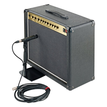 25993 low-profile mic stand in use holding a microphone at the grille of a guitar combo amp, with coiled XLR cable, K&M