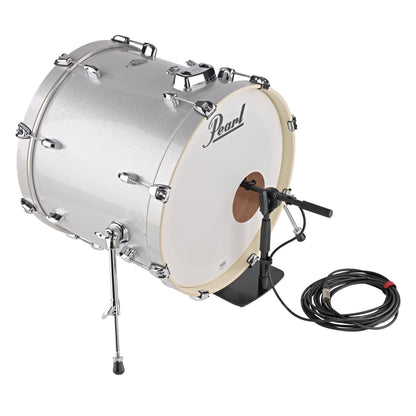 25993 low-profile mic stand set in front of a silver Pearl bass drum with boom extended through the port hole and XLR cable coiled beside it, K&M