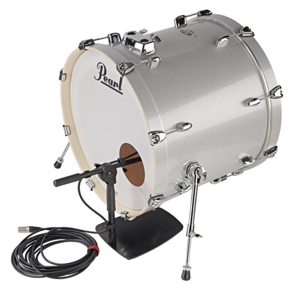 25993 low-profile mic stand beside a Pearl bass drum with boom angled into the front head port hole, flat base on floor and XLR cable coiled, K&M