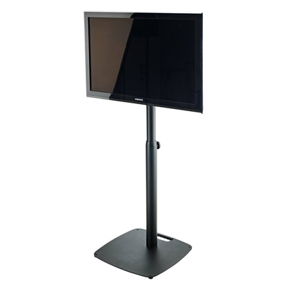 26782 VESA monitor stand in use with flat screen mounted on the black column, showing height-adjustment knob and square base with carry handle, K&M