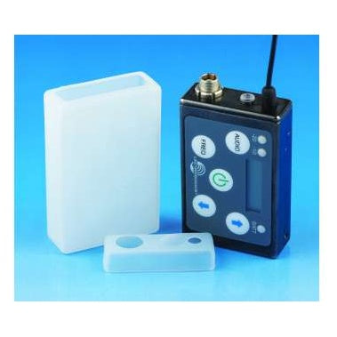 SSMCVR silicone cover components beside SSM transmitter, showing the translucent sleeve and separate end cap next to the unit with its control panel and antenna connector, Lectrosonics