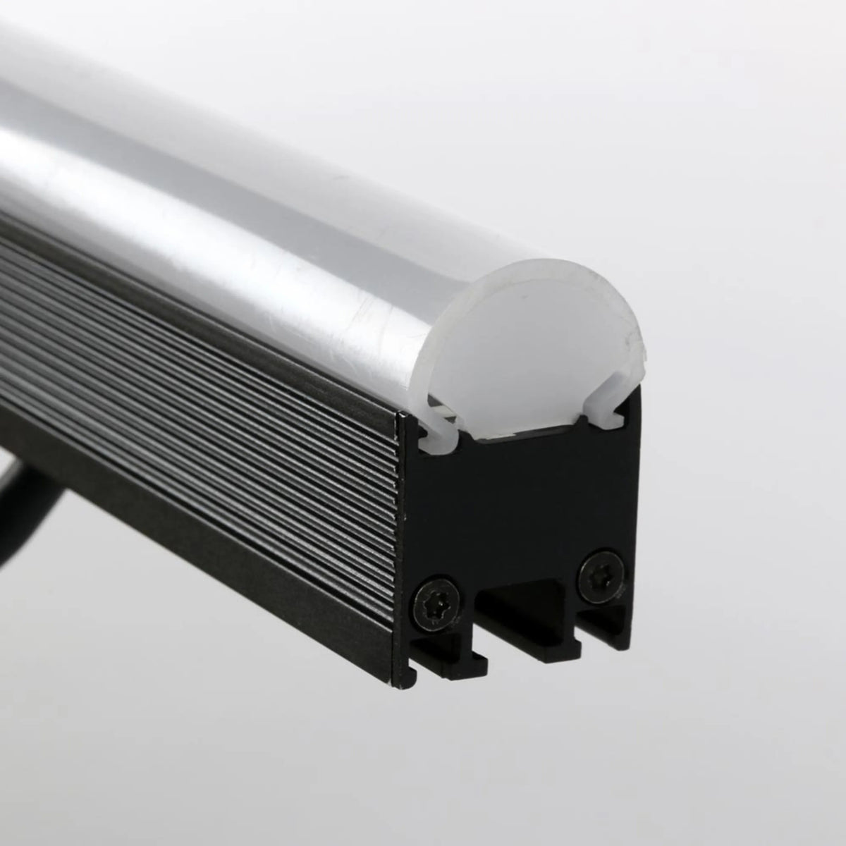 VDO Sceptron 320mm round clear diffuser end detail fitted to finned black extrusion with screw-mounted end cap, Martin Lighting