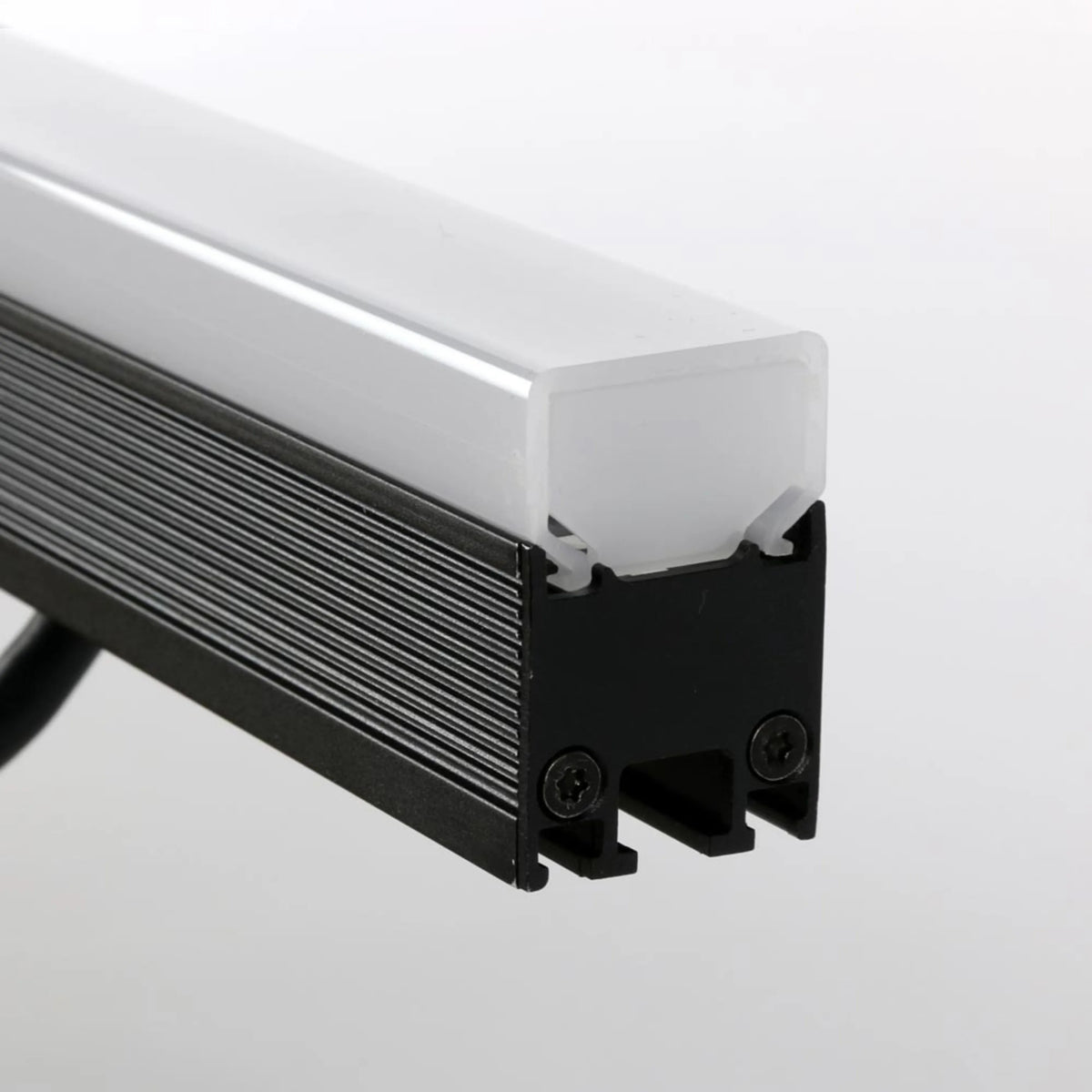 VDO Sceptron 320mm square diffuser detail shot showing frosted lens cap fitted to finned black extrusion with Torx end screws, Martin Lighting